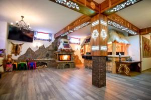 a large living room with a fireplace and a tv at "Czarna Turnia "Zakopane in Zakopane