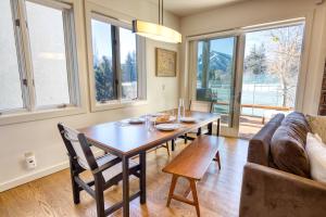 a dining room with a table and a couch at Wildflower Resort Stay - Sun Valley Condo with King Bed and Mtn Views in Sun Valley