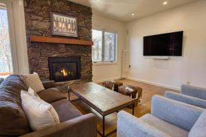 a living room with a couch and a fireplace at Wildflower Resort Stay - Sun Valley Condo with King Bed and Mtn Views in Sun Valley