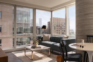 a living room with a couch and large windows at Sonder at Pierce Boston in Boston