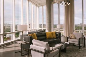 a living room with a couch and chairs and windows at Sonder at Pierce Boston in Boston