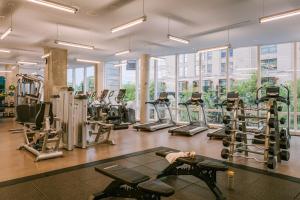 a gym with lots of treadmills and elliptical machines at Sonder at Pierce Boston in Boston