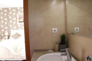 a bathroom with a sink and a mirror and a bed at Residentium Spain -Chalet la Dorada pets friendly in Cambrils +49 photos