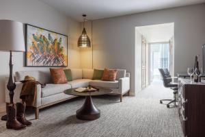 a living room with a couch and a table at Hotel Contessa - Suites on the Riverwalk in San Antonio