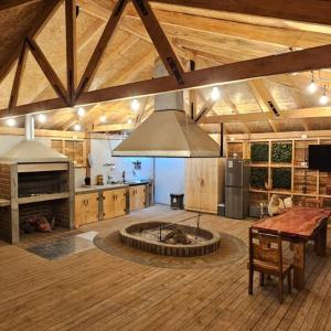 a large kitchen with a fire pit in the middle at Cabañas rio Biobio in Callaqui