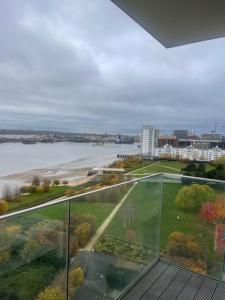 a glass balcony with a view of the water at Waterside heights Dockland in London