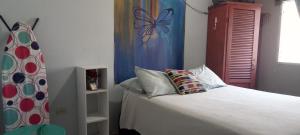 a bedroom with a bed with a butterfly curtain at Casa Pico Bonito 