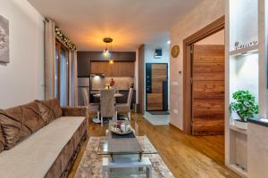 a living room with a couch and a table at Apartman Kostić in Zlatibor