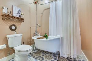a bathroom with a toilet and a bath tub with a shower curtain at Private Pool and Yard Dog-Friendly Bradenton Home in Bradenton +24 photos