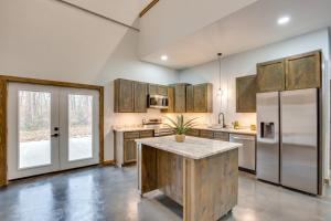 a kitchen with wooden cabinets and stainless steel appliances at Serene Yantis Getaway - 1 Mi to Lake Fork! in Yantis