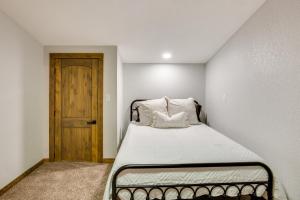 a small bedroom with a bed with a wooden door at Serene Yantis Getaway - 1 Mi to Lake Fork! in Yantis
