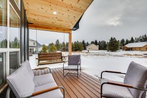 a screened porch with two chairs and a bench at Family-Friendly Donnelly Home with Private Hot Tub! in Donnelly