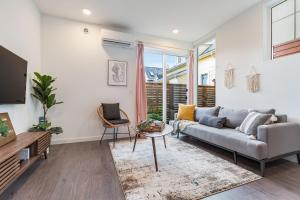 a living room with a couch and a tv at Centro house E BY Betterstay in Seattle