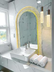 W łazience znajduje się umywalka i lustro. w obiekcie Sandy Heaven Maldives w mieście Gulhi