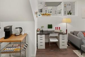 a small kitchen with a desk and a couch at Centro house F BY Betterstay in Seattle
