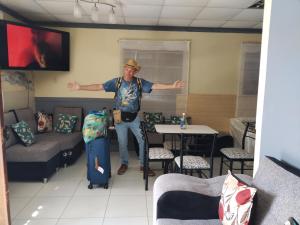 a man standing in a room with his arms outstretched at Qaleta Azul in Camaná