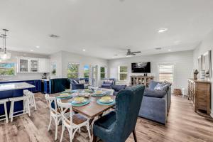 a kitchen and living room with a table and chairs at Paradise on Pine in Anna Maria
