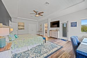 a bedroom with a bed and a ceiling fan at Paradise on Pine in Anna Maria
