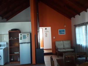 a living room with a refrigerator and a chair at Mi lugar in Piriápolis