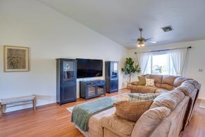 a living room with a couch and a flat screen tv at Thatcher Home with Fenced Backyard 3 Mi to Downtown in Thatcher
