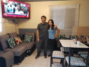 a man and a woman standing in a room at Qaleta Azul in Camaná