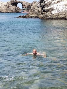 a person swimming in a body of water at Qaleta Azul in Camaná