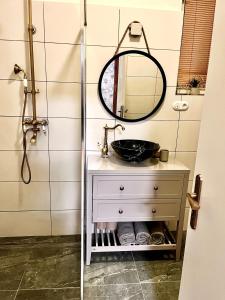 a bathroom with a sink and a mirror at Apartments Zámoček Staré časy in Poprad