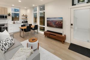 a living room with a couch and a table and a kitchen at Metro Malden BY Betterstay in Seattle