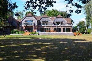 a large house with a large lawn in front of it at The Shallows by inspirestays-com in North Hayling