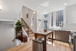 a kitchen with a wooden table and a staircase at Urban Abode 22 BY Betterstay in Seattle