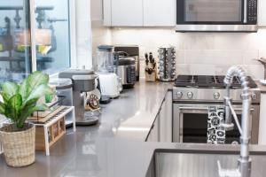 a kitchen with a sink and a counter top at Capitol Luxe Six BY Betterstay in Seattle