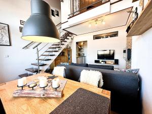 a living room with a table and a couch at FEWO Yeti in Oberstaufen