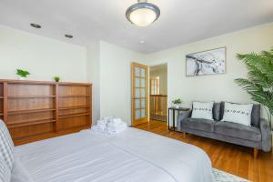 a bedroom with a large bed and a couch at Vintage Seattle Gem BY Betterstay in Seattle