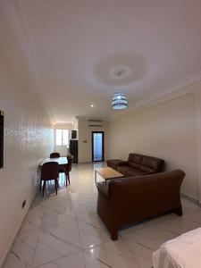 ein Wohnzimmer mit einem Sofa und einem Tisch in der Unterkunft Apartments Plaza Hotel in Kololi