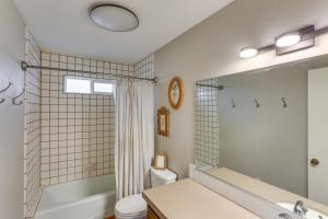 une salle de bain avec un lavabo, des toilettes et un miroir dans l'établissement Mid-Century Mod Cottage, Steps to Lake Gregory!, à Crestline 16 autres photos