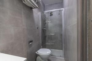 a bathroom with a toilet and a glass shower at Hyper Lodge Termini GuestHouse in Rome