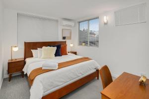 a bedroom with a large bed and a table at Centro House A BY Betterstay in Seattle