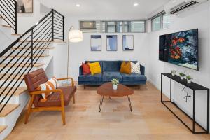a living room with a blue couch and a table at Centro House A BY Betterstay in Seattle
