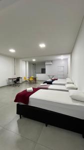 a large room with four beds in it at Flat Central in Bonito