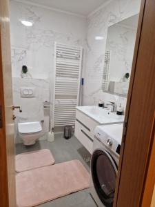 a bathroom with a washer and a washing machine in it at My River Walk apartment - Ilidza in Sarajevo
