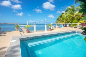 a swimming pool with the ocean in the background at Del Playa #4 - 278851 Condo in West End