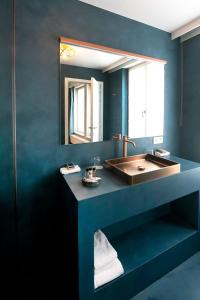 een badkamer met een wastafel en een spiegel bij Hotel 'T Sandt in Antwerpen