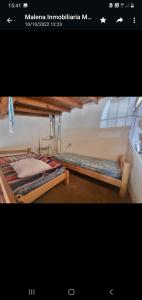 two beds are sitting in a room with at 9 amigos in Villa Gesell
