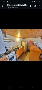 a kitchen with a stove and a refrigerator at 9 amigos in Villa Gesell