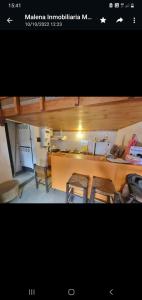 a picture of a kitchen with a table and chairs at 9 amigos in Villa Gesell
