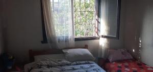 a bedroom with a bed and a window at 9 amigos in Villa Gesell