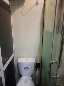 a small bathroom with a toilet and a shower at Berkley House in Lagos
