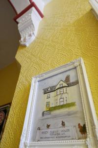 a picture of a house in a frame on a table at Abbey Guest House in Norwich