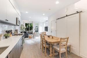 a kitchen and dining room with a table and chairs at View on Franklin BY Betterstay in Seattle