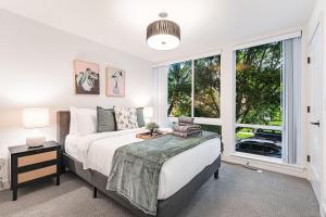 a bedroom with a bed and a large window at View on Franklin BY Betterstay in Seattle